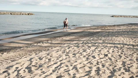 Man on beach with metal detector Stock Footage 249894725