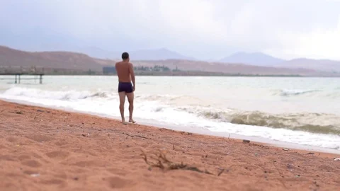 Man on the beach by the sea Stock Footage 95165628