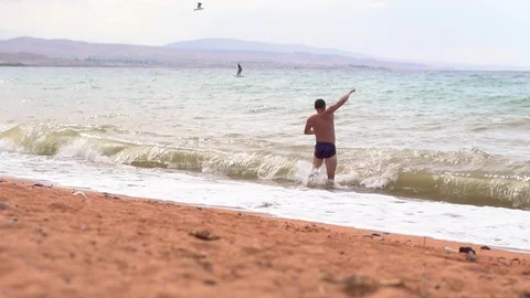 Man on the beach by the sea Stock Footage 95977551