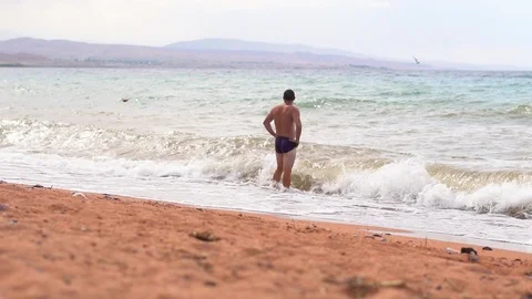 Man on the beach by the sea Stock Footage 96426314