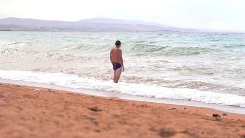 Man on the beach by the sea Stock Footage 104949318