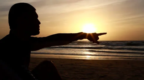 Man on the beach at sunset Видео 22538856