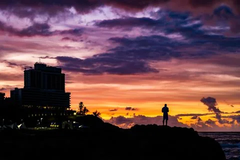 Man at the beach at sunset Stock Photos