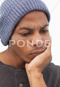 Man in beanie hat looking thougtful Stock Photos
