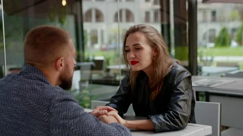 A man with a beard and a blonde with bright lipstick look at each other and hold Stock Footage 178058635