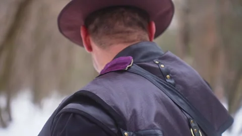 A man with a beard and a fur hat walks in the snow Vidéo 270486438