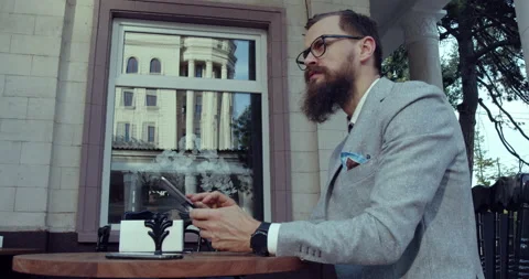 A man with a beard and glasses, dressed in business clothes, Stock Footage 138809413