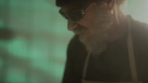 Man with a beard and glasses standing in a dusty room Stock Footage 274994352