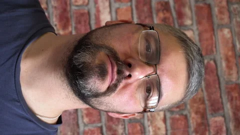 A man with a beard and glasses. Vertical video 4K Stock-Footage 150287135