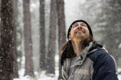 A man with a beard and a hat is smiling in the snow 写真素材