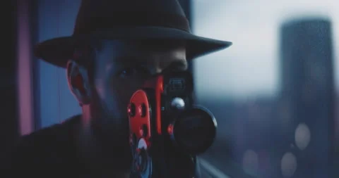 Man with beard and hat using vintage camera to take photos Stock Footage 203573854