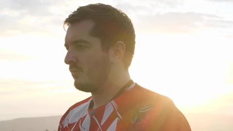 Man with beard and moustache in red motocross uniform Stock Footage 112475408