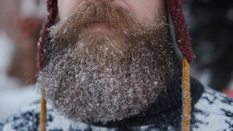 Man with beard and mustache blows snow,concept of Christmas and new year Stock Footage 127553179