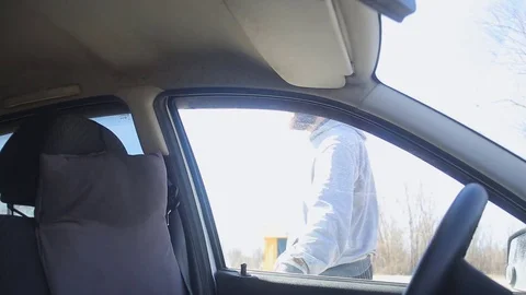 A man with a beard and in sporting clothes get into the car Stock Footage 75161656