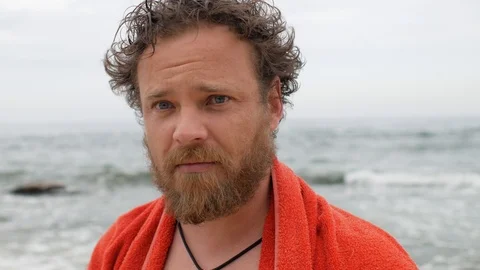 Man with a beard and a wet head against the background of the sea after swimming Stock Footage 108112718