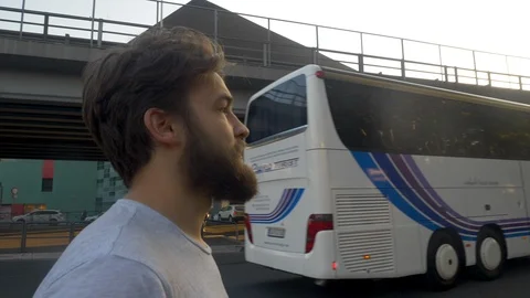 Man with beard and white tee shirt eagerly looking around for someone. It Stock Footage 120600294