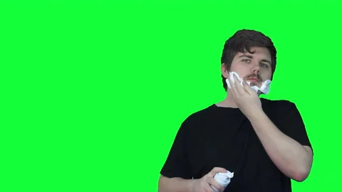 Man with beard applies white foam for shaving face. Clip. Green screen with Stock Footage 224933726