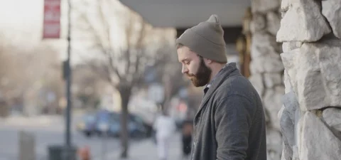 Man with Beard in Beanie Leaning Against Wall Profile Stock Footage 87103670