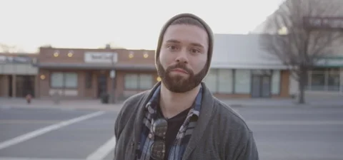 Man with Beard in Beanie looks up into the Camera Video stock 87103979