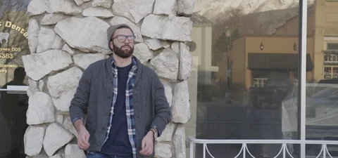 Man with Beard in Beanie putting on Glasses Stock Footage 87104112