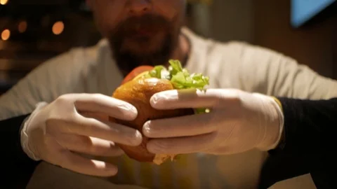Man with a beard bites a burger. cheeseburger Stock Footage 99822539