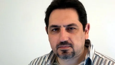 A man with a beard blinks one eye Stock Footage 93097904