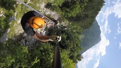 Man with beard canopying over the forest on zipline in Slovenia. Stock Footage 97062136
