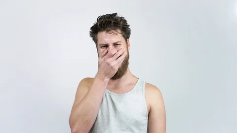 The man with the beard crying.A young guy cries and tries. Stock Footage 122371938