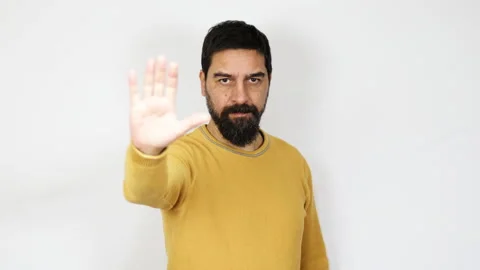 Man with beard doing stop hand sign gesture. Denying, rejecting, disagree. Stock Footage 165767743
