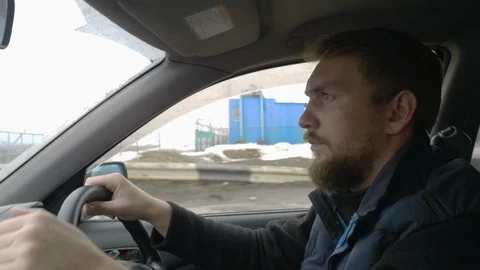 A man with a beard driving in the car Stock Footage 105719694