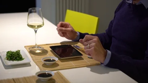 Man with a beard eating chuka salad and drinking white wine during the .. Stock Footage 71556595