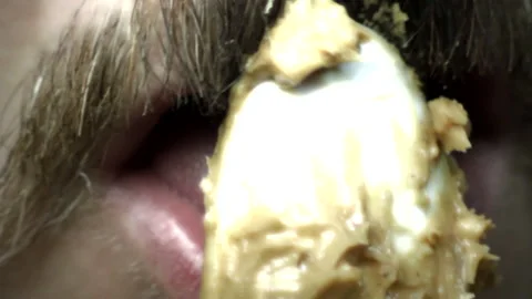Man with Beard Eats Peanut Butter Stock Footage 134760675
