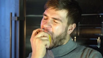 A man with a beard eats a yellow apple Stock-Footage 86148476