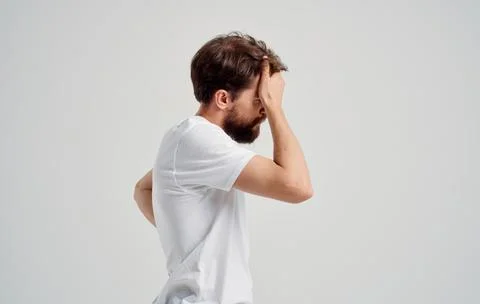 A man with a beard gesturing with his hands back pain spine load heaviness Stockfoto's