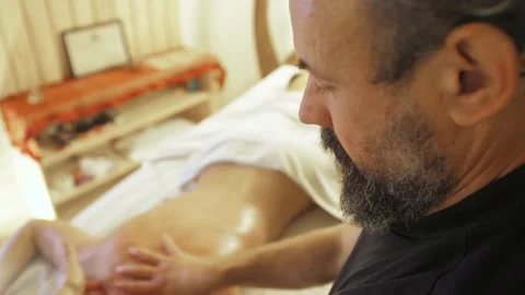 Man with a beard gives a back massage to a woman Stock Footage 140992052