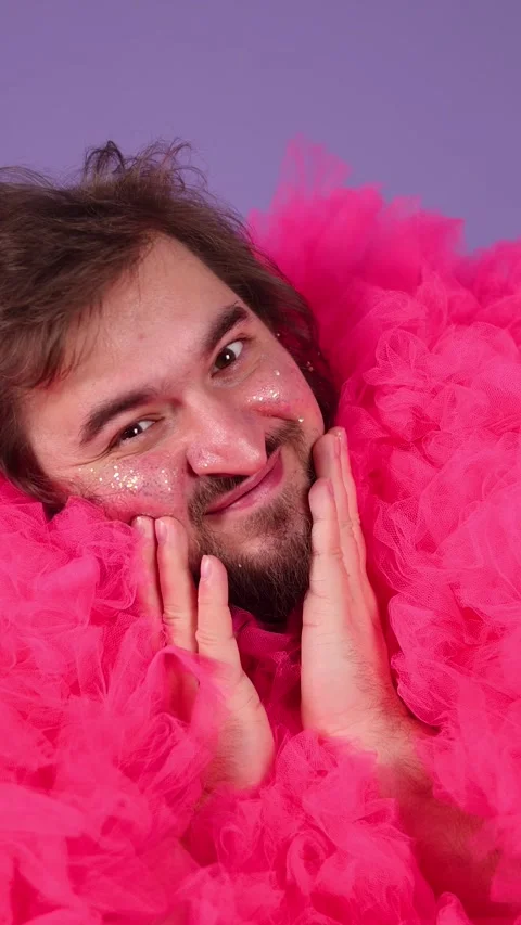 Man with beard, glitter sparkles on face, magenta tulle fur coat Stock Footage 337831902