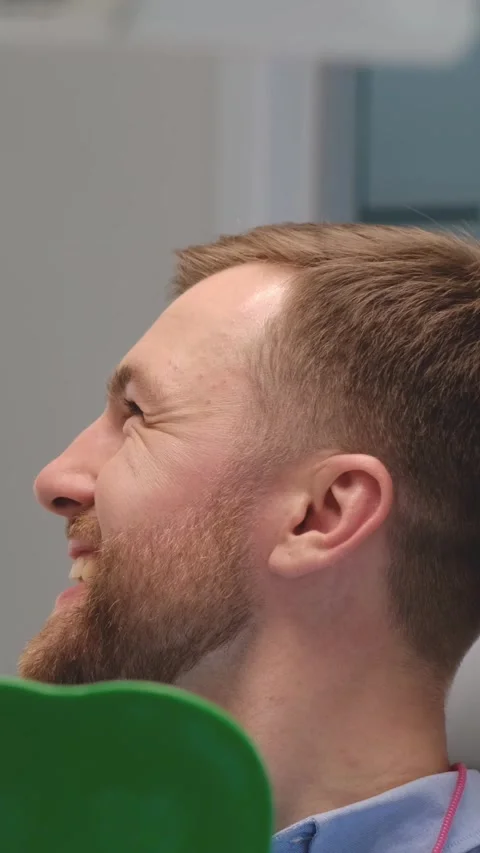 A man with a beard happily studies his mirrored reflection. Stock Footage 264694049