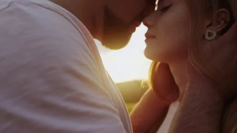 Man with beard holding woman's head with tenderness, close up. Couple with Stock Footage 252534403