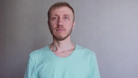 Man with a beard looks into the camera Stock Footage 128179798