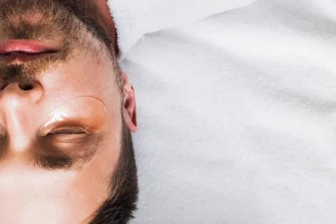 Man with beard lying and relaxing with golden patches 스톡 사진