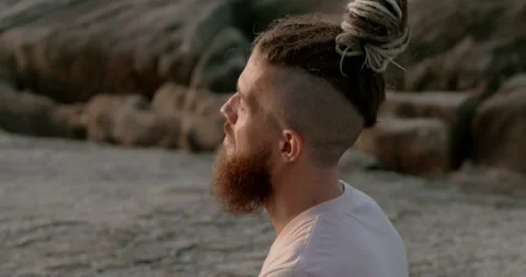 Man with beard meditating sea beach side view eyes closed close-up Seeking Stock Footage 274518517