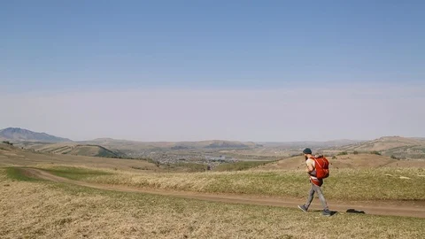 Man with beard mustache backpack goes road against background of the city Stock Footage 111237813