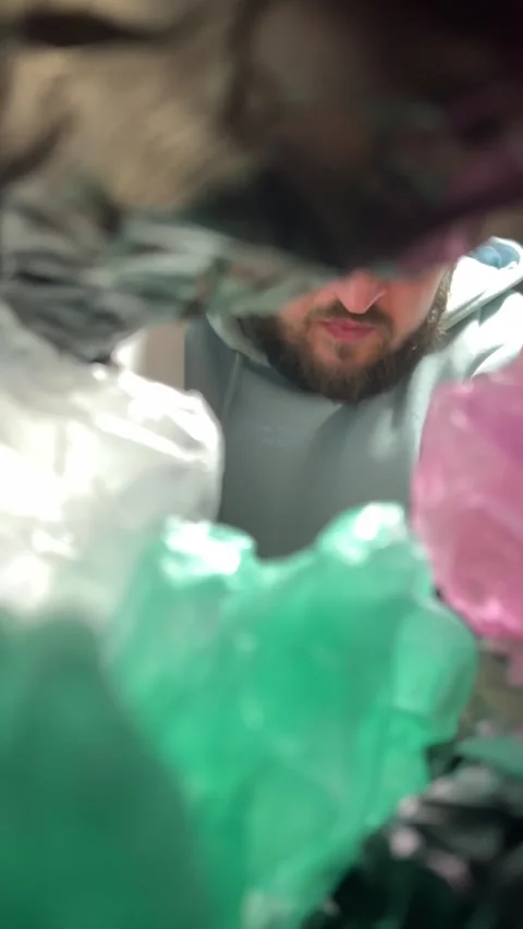 Man with beard out of focus takes out pink and black bag from closet Video stock 304765772