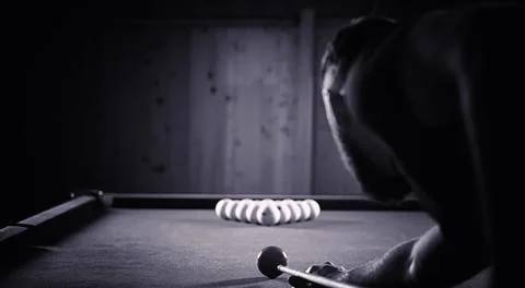A man with a beard plays a big billiard. Party in a 12-foot pool. Billiards.. Stock Photos