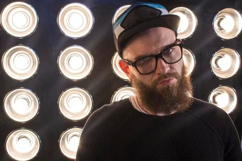 Man with a beard. Portrait of a bearded guy in a cap against a backdrop of .. Stock Photos