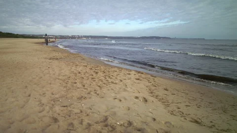 Man with Beard in Protective Face Mask Running by the Beach at Dusk - Wide Stock Footage 130738361