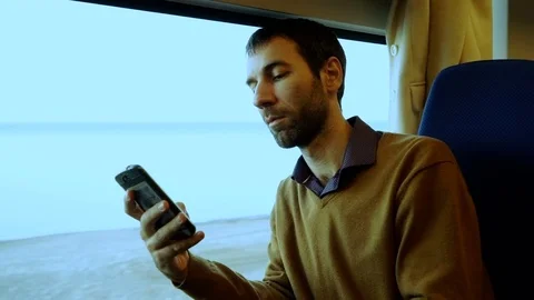 A man with a beard is reading an e-book Stock Footage 73421693