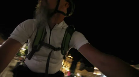 Man with beard riding bicycle at night in town Stock Footage 67305046