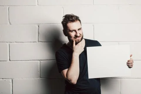 Man with beard showing blank white card Stock Photos