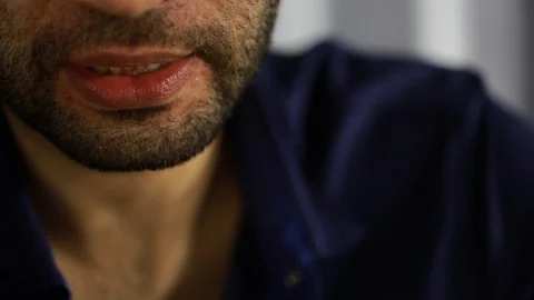 A man with a beard sitting in the room says something Stock Footage 124778853